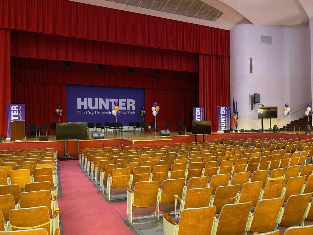 An assembly hall in Hunter's North building is empty but contains balloons and seats for the few small programs that were able to hold in-person graduation ceremonies.